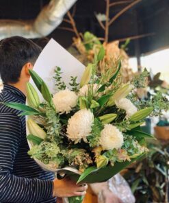 Man Holding A Bouquet of White Flowers