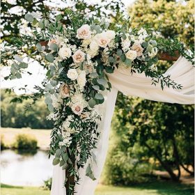 outdoor angle of wedding venue showing flower decoration and white curtain