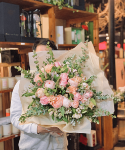 Woman holding a bouquet of pink roses